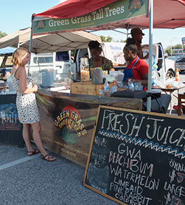 Customer purchasing a fresh-squeezed juice at the Govans Farmers' Market