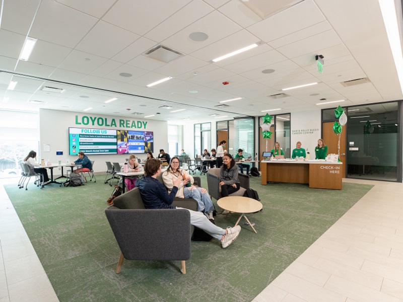 Students gather on couches and at tables in the Rizzo Career Center atrium