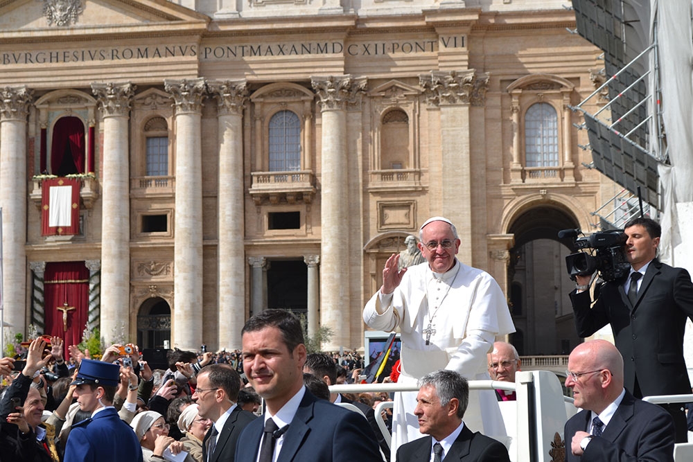 Pope Francis waves to the crowd at St. Peter's Square during his first Easter Mass as pope in 2013 (Emily Griffin, '14).