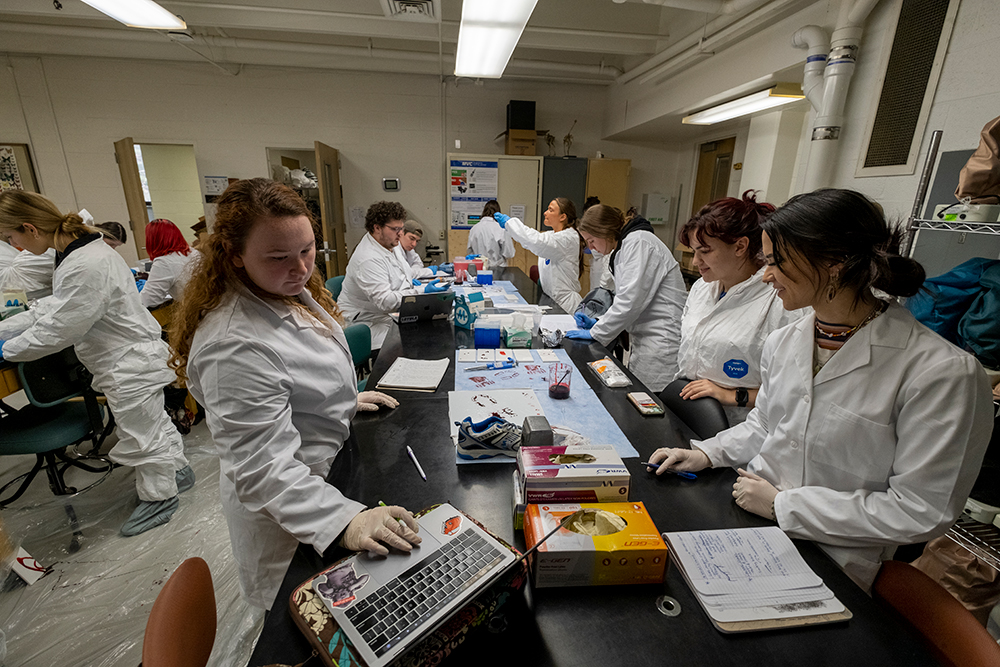 Loyola students in a forensic science laboratory class.