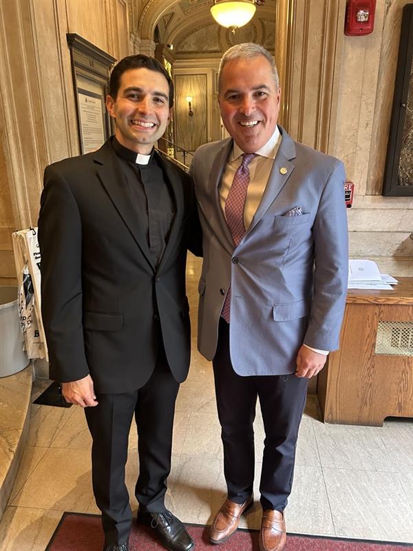 The Rev. Jonathan Pennacchia, S.J., ’14, and Terrence M. Sawyer, J.D., president of Loyola.