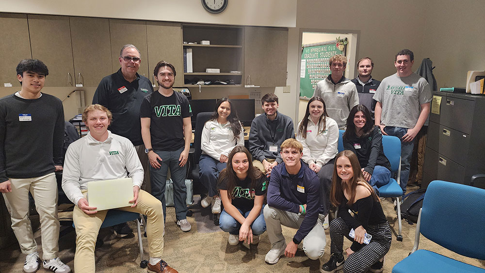 Michael W. Bender, executive in residence of accounting who helps coordinate Loyola’s VITA program, with Loyola's VITA students.