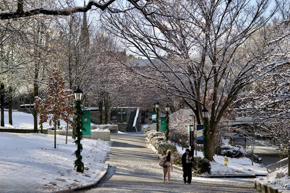 Students walking on a snow-covered Evergreen campus