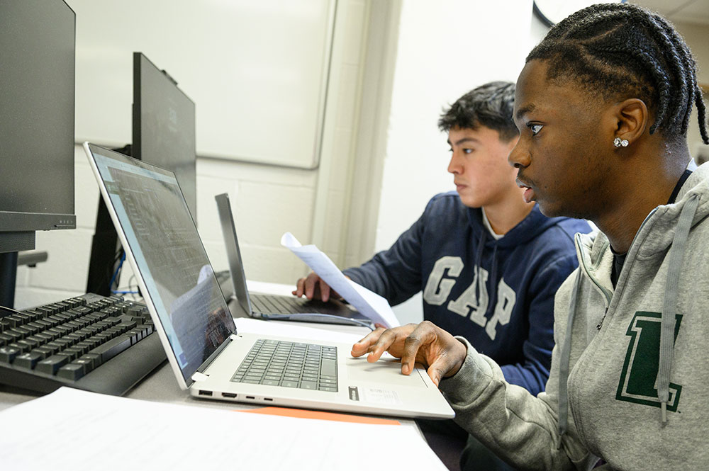 Loyola students work at a computer