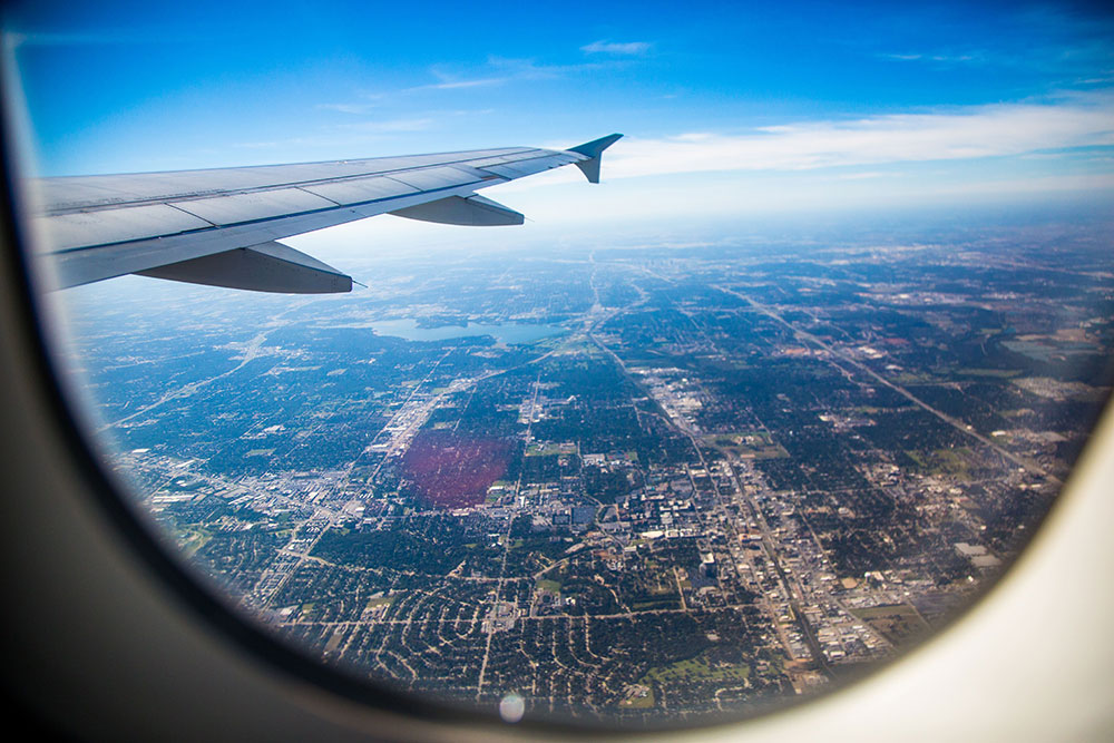 A photo from the window of a plane above a city