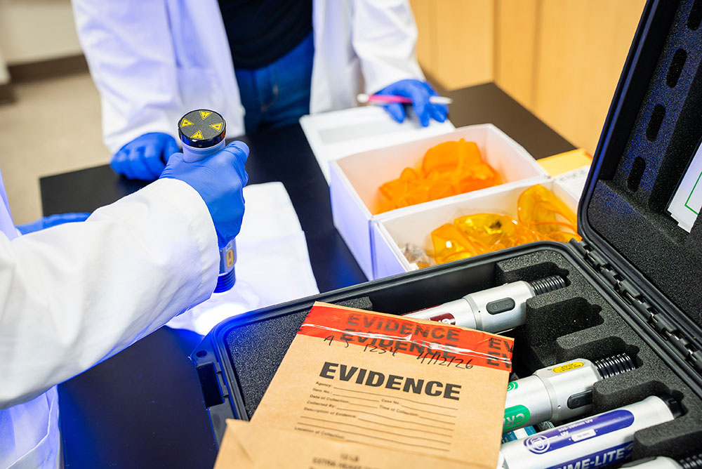Loyola students practice examining and logging evidence in a forensic science class