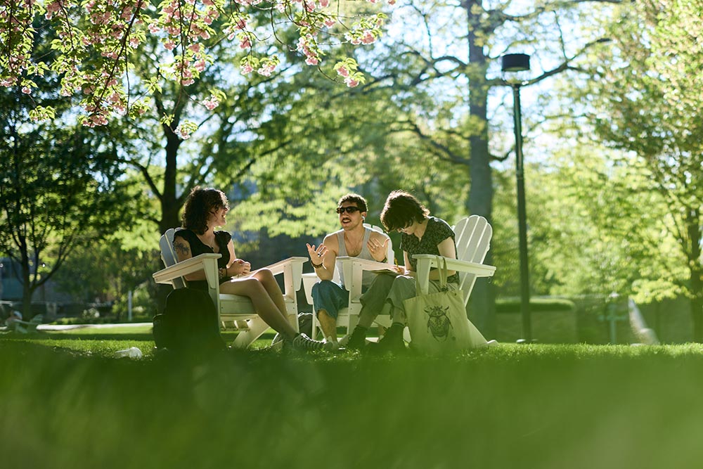 Student sit on Loyola's academic quad