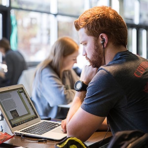 Student works at laptop
