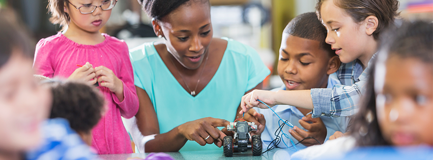 Teacher and Students working on remote control car