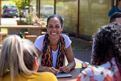 Woman smiling at another person