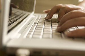 Fingers typing on a keyboard