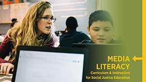 Teacher sitting at computer with student
