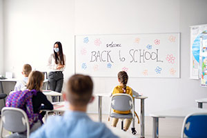 Teacher in classroom with students with masks on