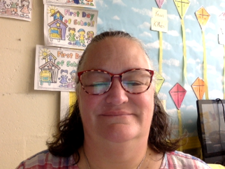 Woman with shoulder-length hair and glasses