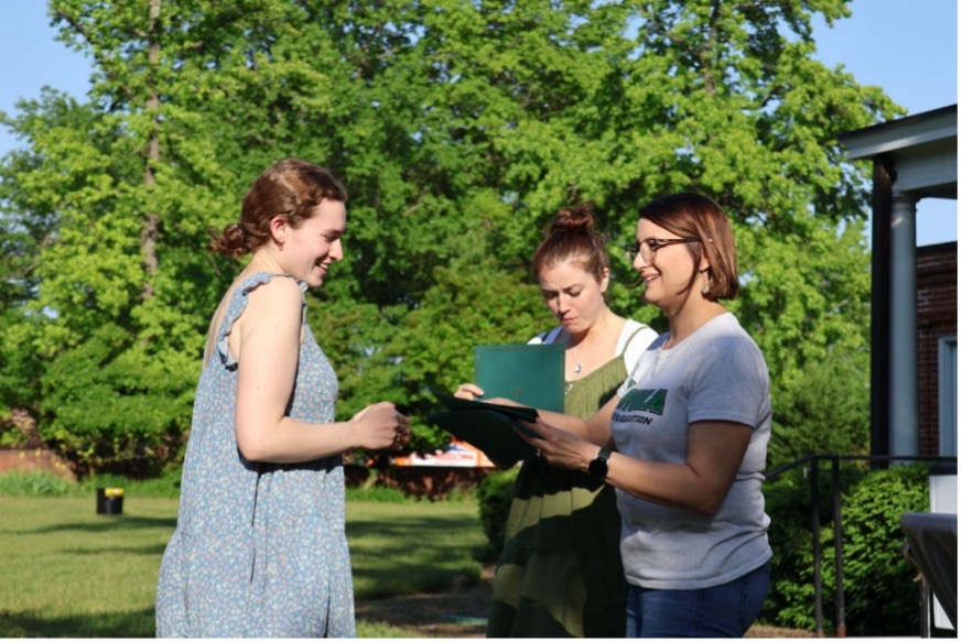 2 women receiving education awards from Stacy Williams, the Chair of Teacher Education