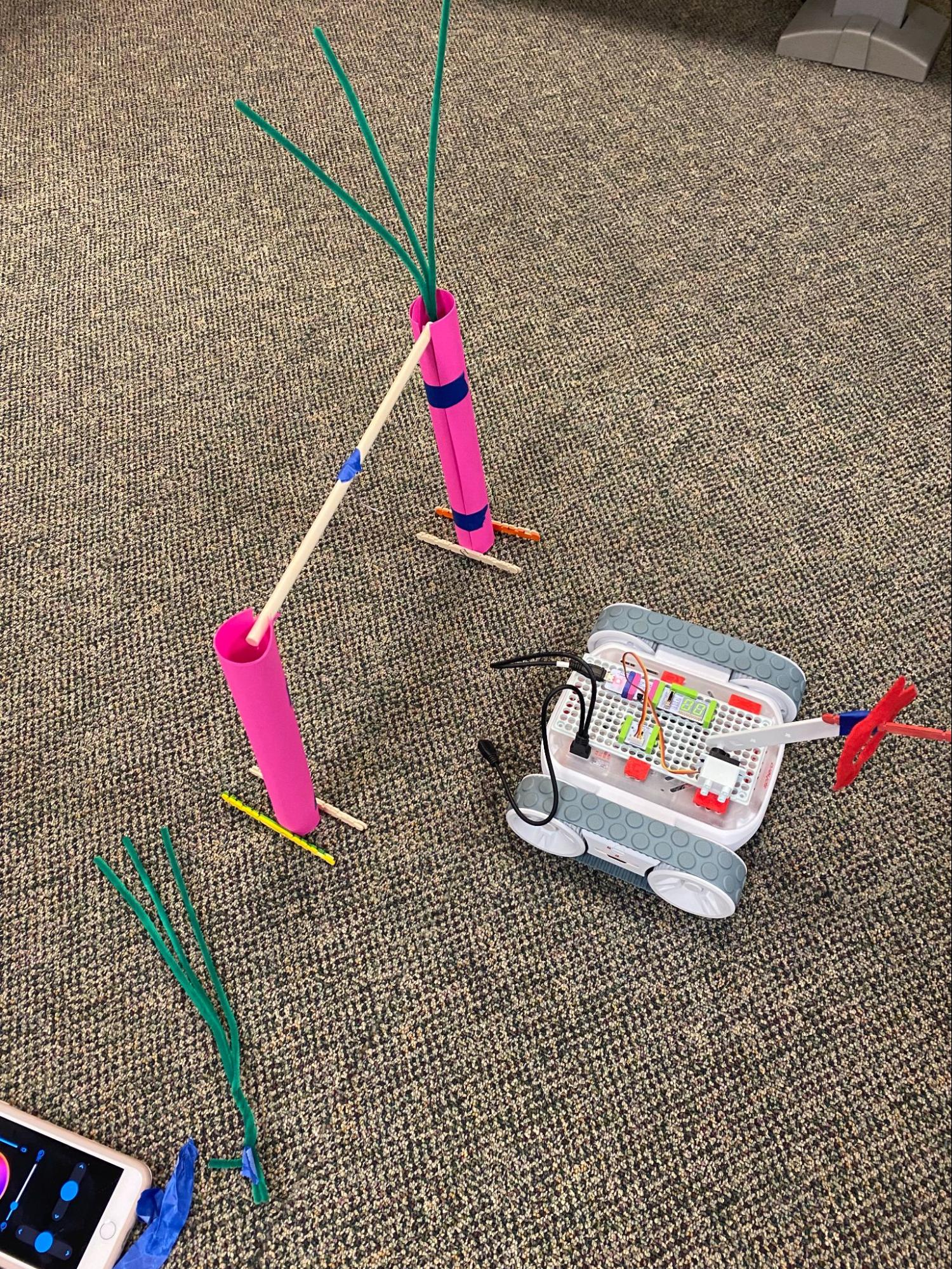 electronic toy car going through obstacles on carpet