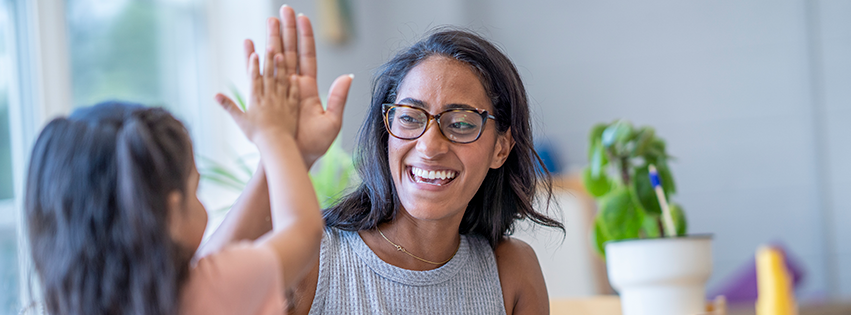 Woman high-fiving a child