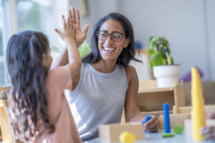 Woman high-fiving a child