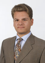 Luciano Betman poses for a picture with a suit and tie