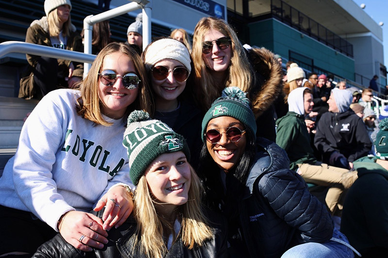 Students smiling for the camera while in the crowd at the Ridley Athletic Conference