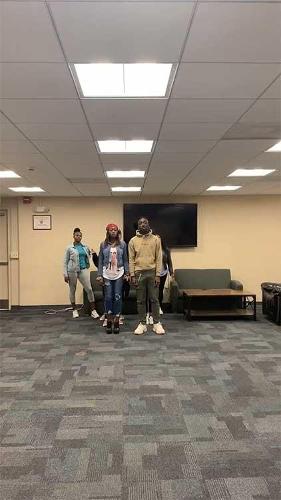 Students lining up in an academic room to practice for the show.