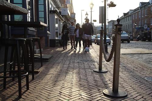 Students walking on a brick sidewalk in downtown Baltimore