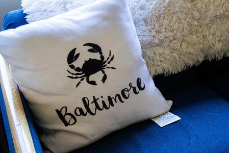 A pillow with Baltimore and a crab on it