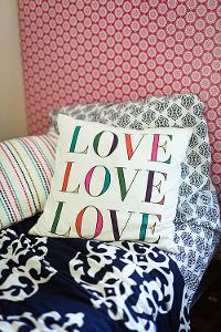 Dorm pillows beneath a tapestry