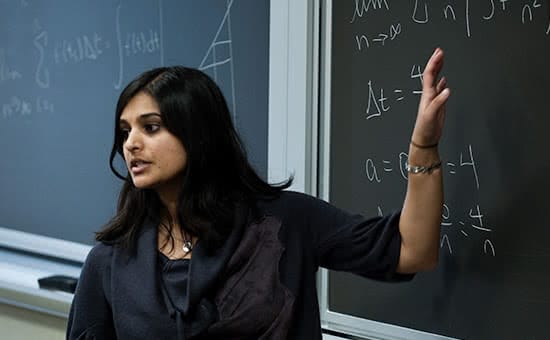 A math professor teaching in front of a blackboard