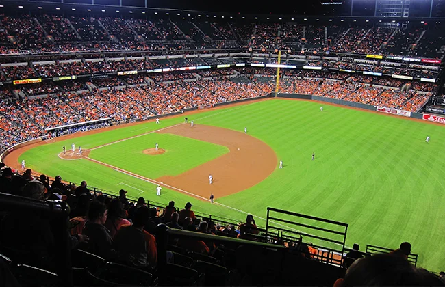 The Baltimore Orioles on the field during a night game at Camden Yards