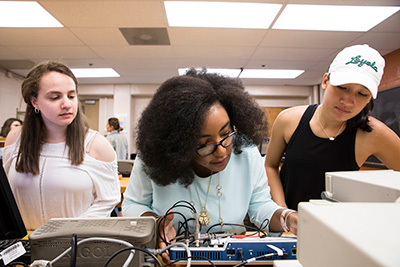 Students working with electronics in an engineering lab